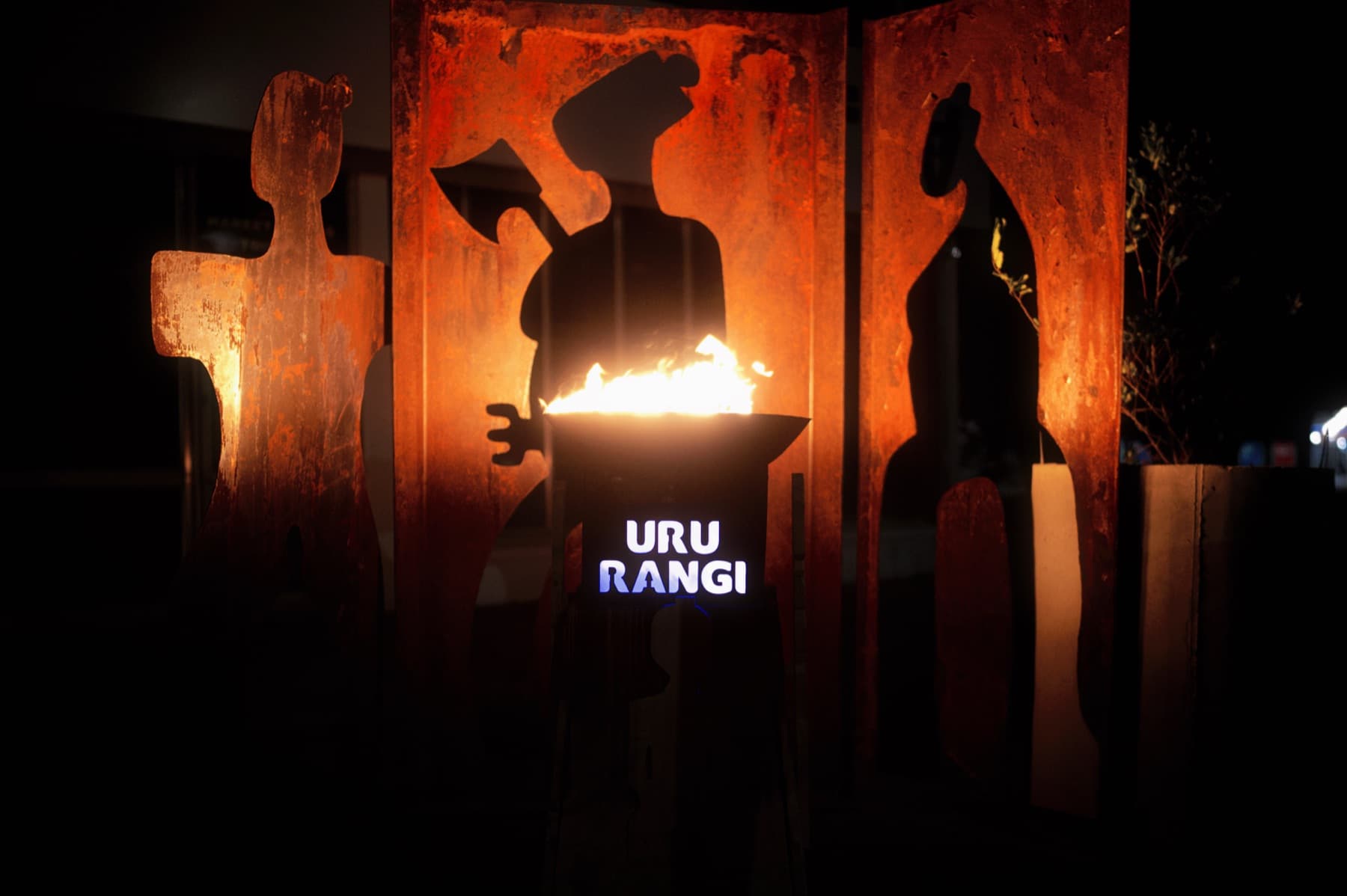URU RANGI firepit with lit steel name sign at the Te Ahi o Matariki installation